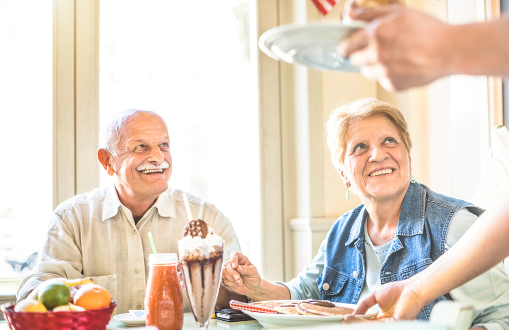 Rosemont senior living facilities, Sacramento, CA, Rosemont, CA, waiter,serving,senior,retired,couple,eating,cakes,at,fashion,bio, finding senior living care